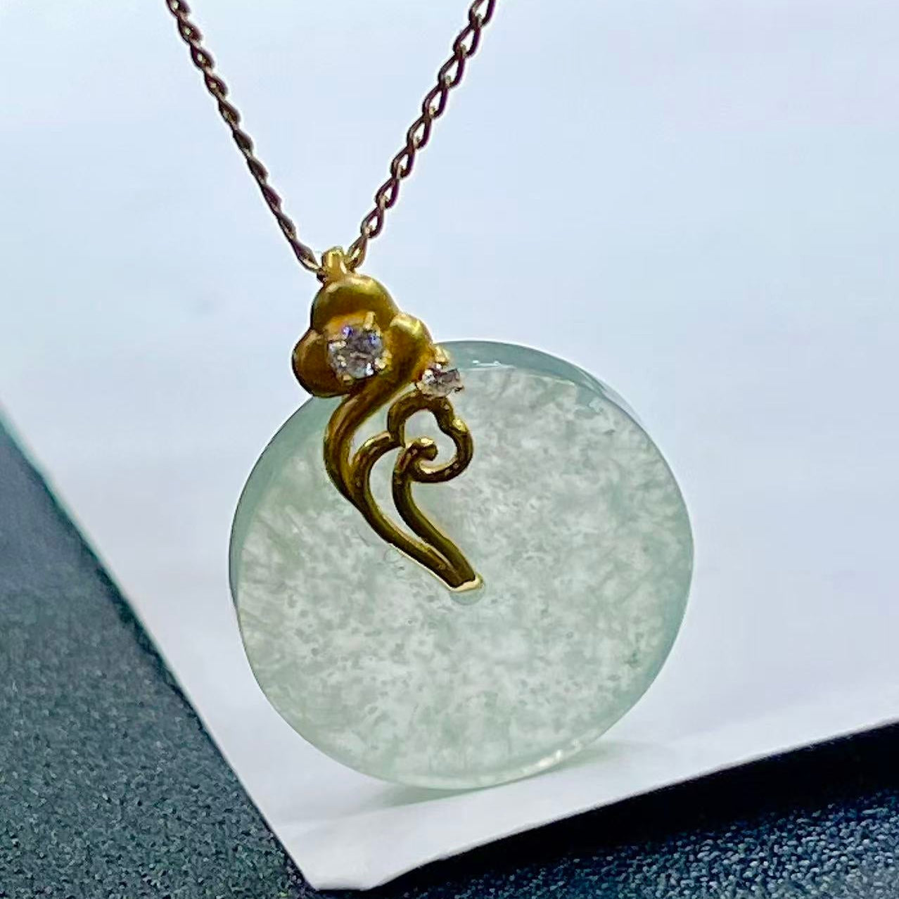 Ice-type jade Ping An Kou with snowflake inclusions  18K gold with auspicious cloud design, symbolizing peace and smooth life
