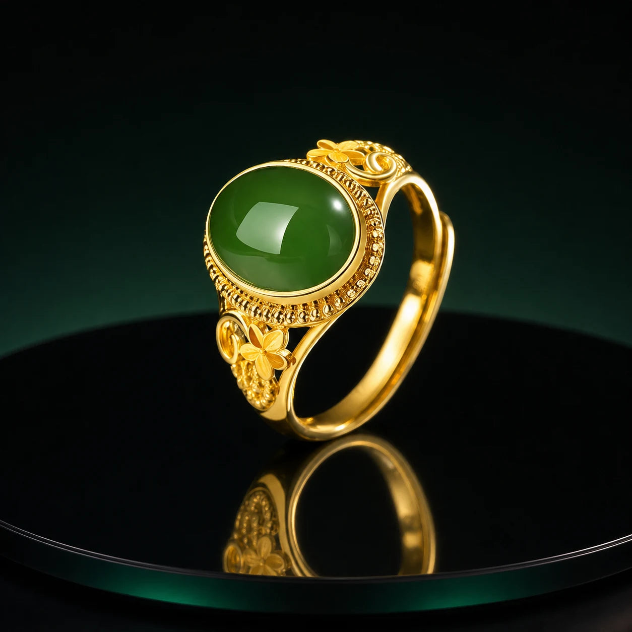 Green cabochon ring on an obsidian mirror